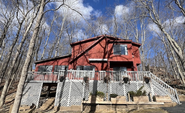 rustic home featuring stairs and a deck