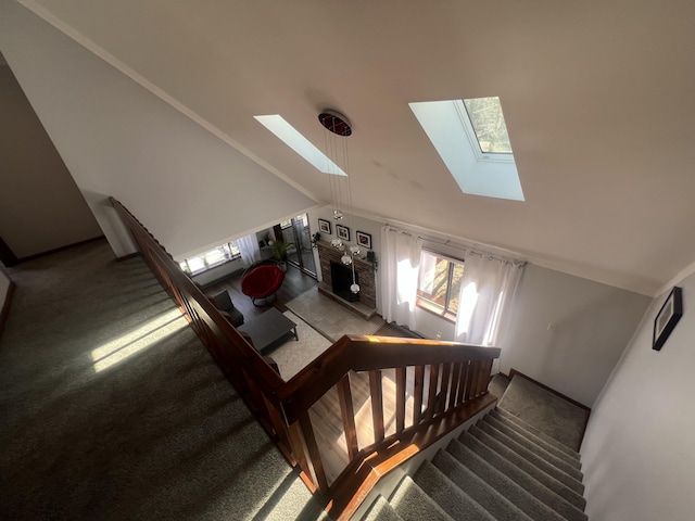 staircase with vaulted ceiling with skylight