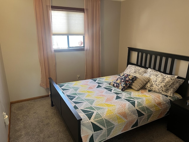 bedroom featuring carpet and baseboards