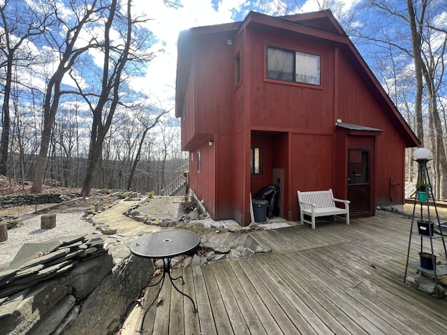 back of property featuring a wooden deck