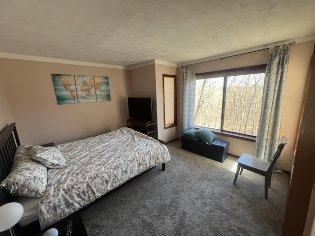 bedroom featuring a textured ceiling, ornamental molding, and carpet