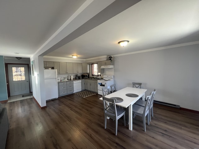 dining room featuring dark wood-type flooring, crown molding, and baseboards