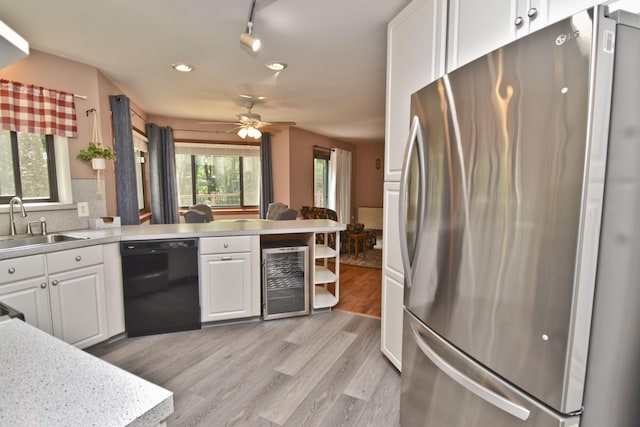 122 Mcmichaels Ct, Stroudsburg, PA 18360 - kitchen with freestanding refrigerator, dishwasher, wine cooler, white cabinets, and recessed lighting