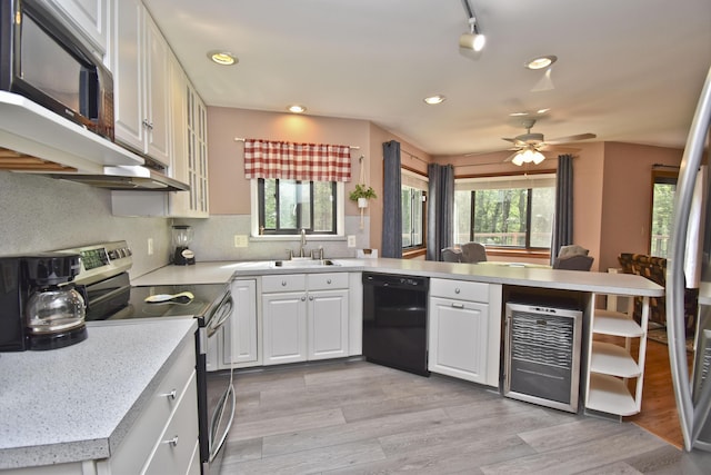 122 Mcmichaels Ct, Stroudsburg, PA 18360 - kitchen with black dishwasher, electric stove, beverage cooler, a peninsula, and plenty of natural light