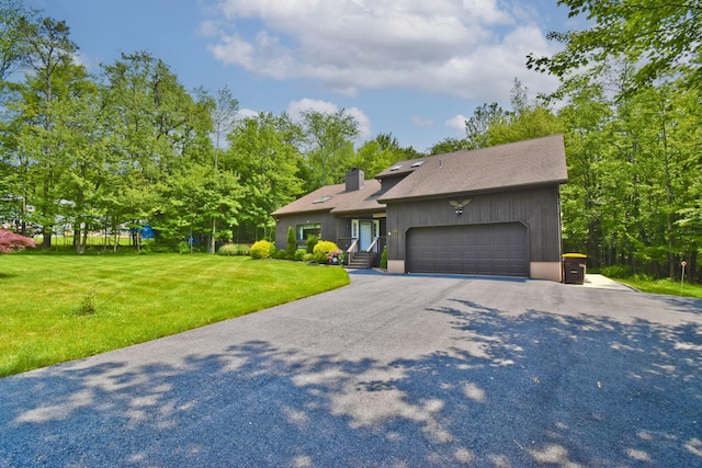 122 Mcmichaels Ct, Stroudsburg, PA 18360 - view of front of house with a chimney, an attached garage, a front lawn, driveway, and a shingled roof