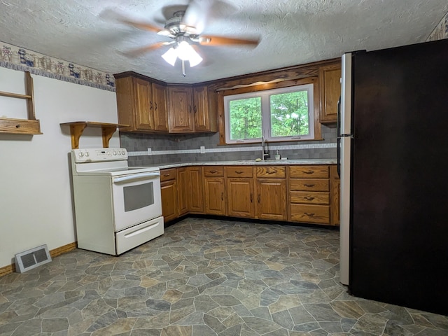 124 Sterling Valley Rd, Kunkletown, PA 18058 - kitchen featuring white range with electric stovetop, freestanding refrigerator, stone flooring, open shelves, and a textured ceiling