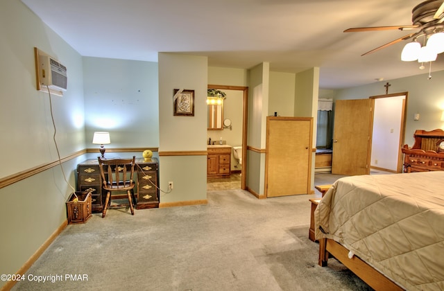 carpeted bedroom featuring a wall mounted air conditioner, a sink, connected bathroom, and baseboards