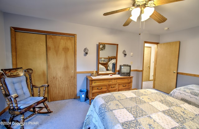 carpeted bedroom featuring a ceiling fan and a closet