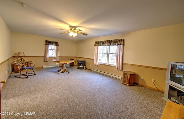 interior space featuring carpet floors, a baseboard radiator, baseboards, and ceiling fan