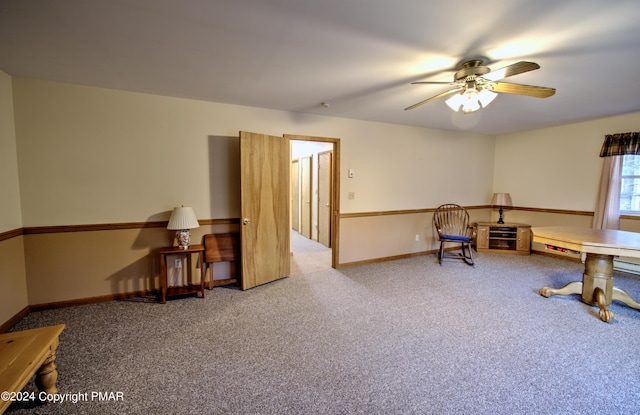 interior space featuring carpet floors, a ceiling fan, and baseboards