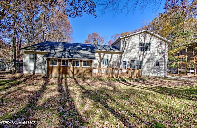 back of property featuring a wooden deck