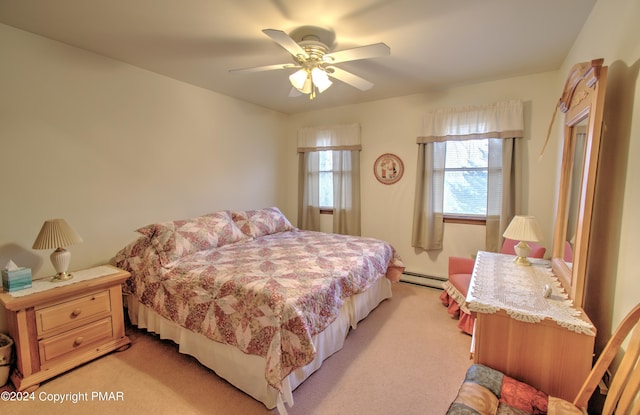 bedroom featuring light carpet, baseboard heating, and a ceiling fan