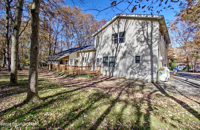 view of side of property with metal roof and a deck