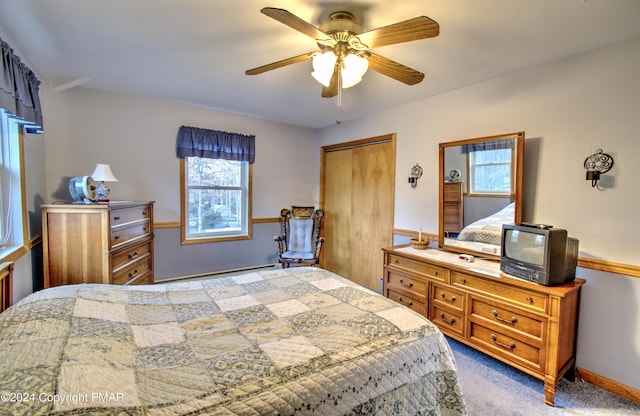 carpeted bedroom featuring ceiling fan and a closet