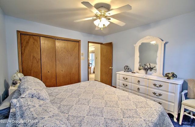 bedroom with ceiling fan and a closet