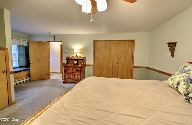 bedroom with a ceiling fan, a baseboard heating unit, and carpet flooring