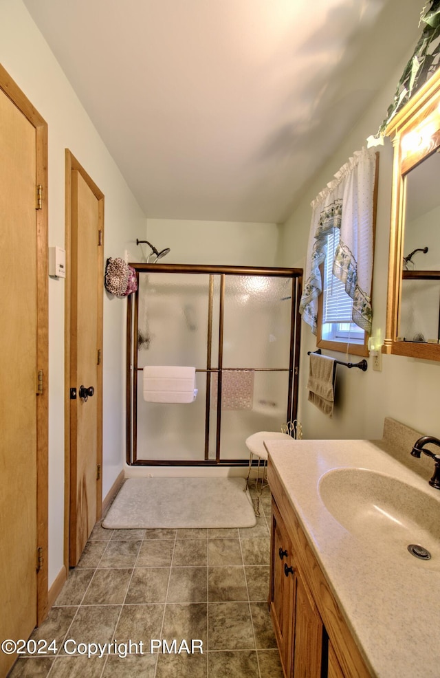 full bath with a shower stall and vanity