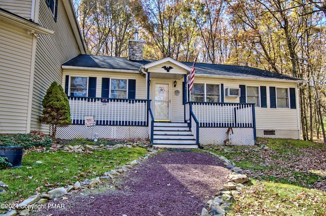 view of front of home with covered porch and a chimney