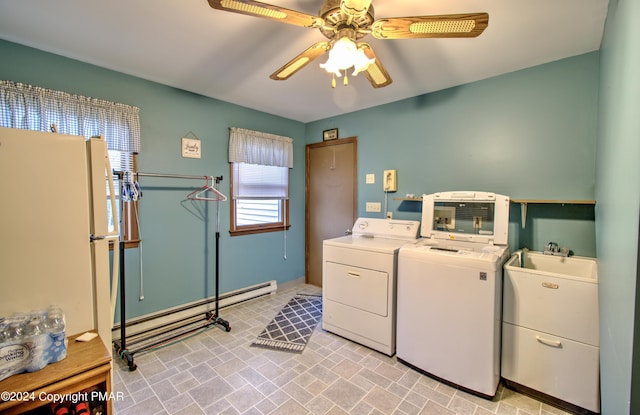 laundry room featuring laundry area, independent washer and dryer, a baseboard radiator, and a ceiling fan