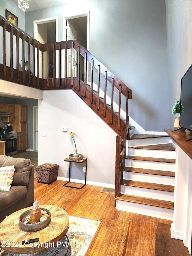 8237 Natures Dr, Tobyhanna, PA 18466 - stairs featuring baseboards, wood finished floors, and a towering ceiling