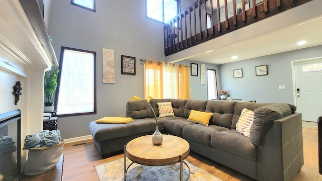 8237 Natures Dr, Tobyhanna, PA 18466 - living room featuring wood finished floors, visible vents, baseboards, a high ceiling, and recessed lighting