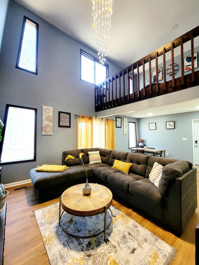 8237 Natures Dr, Tobyhanna, PA 18466 - living area featuring visible vents, a high ceiling, an inviting chandelier, and wood finished floors