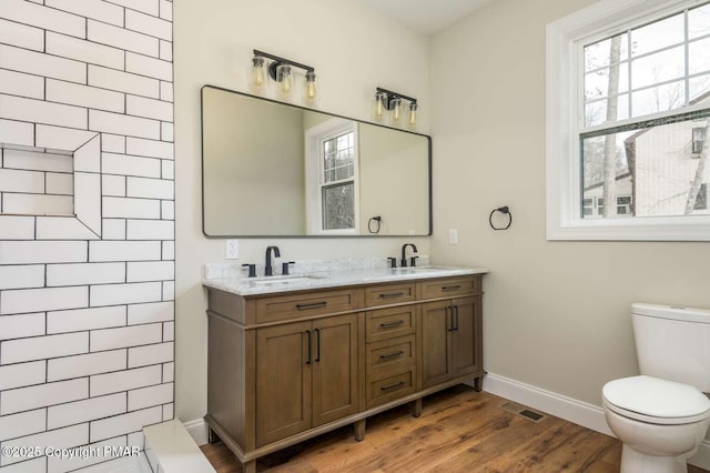 bathroom featuring vanity, toilet, and hardwood / wood-style floors