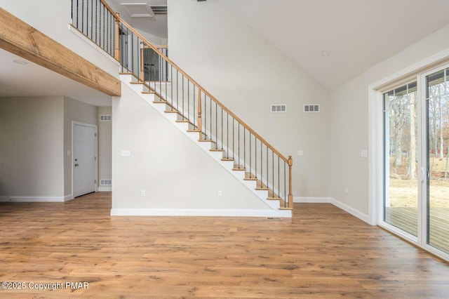 interior space featuring hardwood / wood-style flooring and high vaulted ceiling