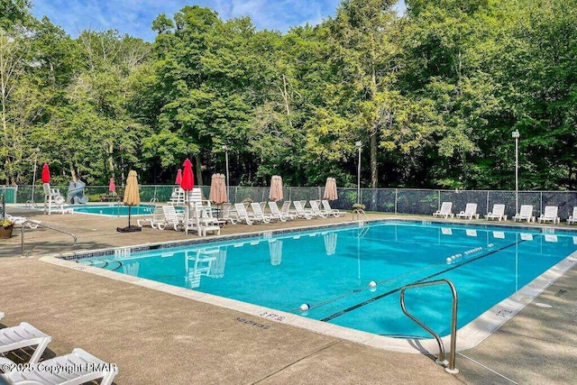 view of swimming pool featuring a patio area