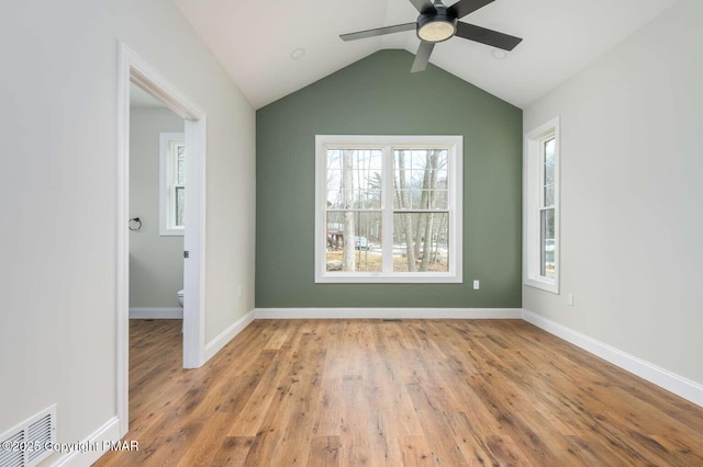 unfurnished room featuring lofted ceiling, light hardwood / wood-style floors, and ceiling fan