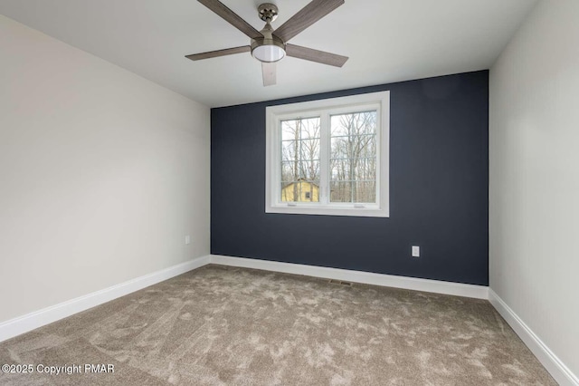 spare room featuring ceiling fan and light carpet