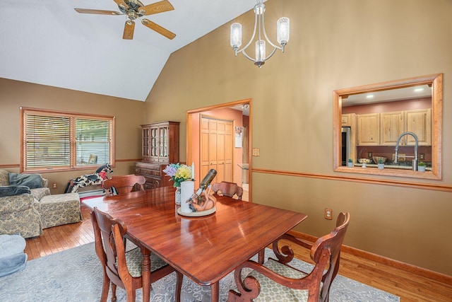 596 Chestnut St, East Stroudsburg, PA 18301 - dining room with ceiling fan, wood finished floors, high vaulted ceiling, a chandelier, and baseboards
