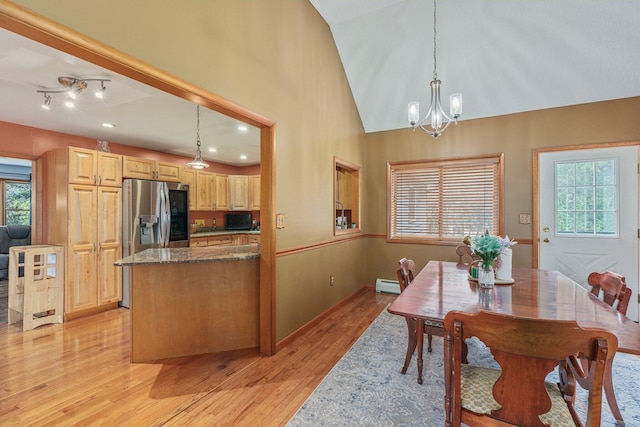596 Chestnut St, East Stroudsburg, PA 18301 - dining space featuring a chandelier, light wood-type flooring, baseboard heating, baseboards, and lofted ceiling