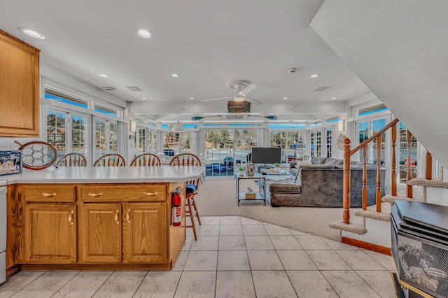 kitchen featuring light carpet, a peninsula, light countertops, and recessed lighting