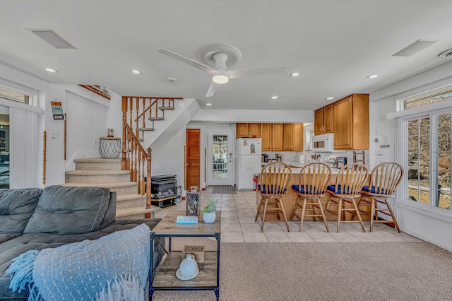 living area featuring visible vents, ceiling fan, stairs, light tile patterned flooring, and recessed lighting