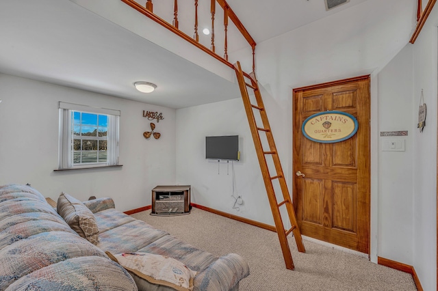 living room featuring carpet and baseboards