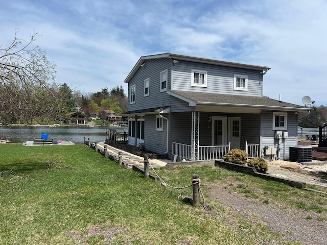 92 S Lake Dr, Lake Harmony, PA 18624 - view of front of home featuring a porch, a water view, a front lawn, and central AC unit