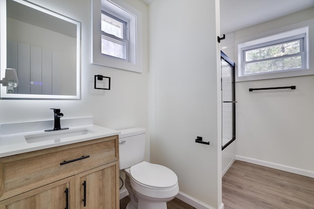 171 Knob Rd, Mount Pocono, PA 18344 - full bath with toilet, baseboards, enclosed tub / shower combo, vanity, and wood finished floors