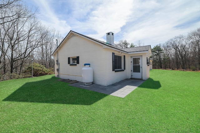 171 Knob Rd, Mount Pocono, PA 18344 - back of house with a chimney, a yard, a patio area, and brick siding