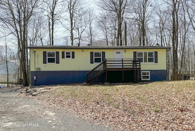 view of front of property featuring a deck and stairs