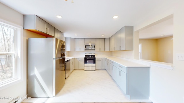 kitchen featuring appliances with stainless steel finishes, recessed lighting, and gray cabinets