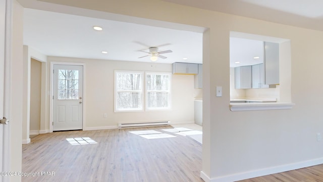 foyer entrance with ceiling fan, a baseboard radiator, light wood-style flooring, recessed lighting, and baseboards