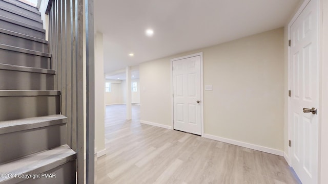 corridor with light wood-style floors, recessed lighting, and baseboards