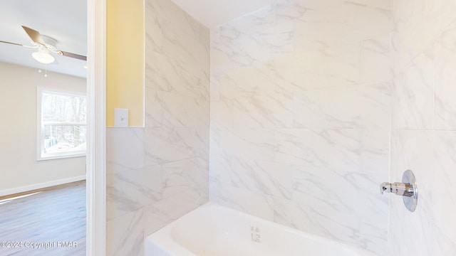 bathroom featuring shower / bathtub combination and ceiling fan