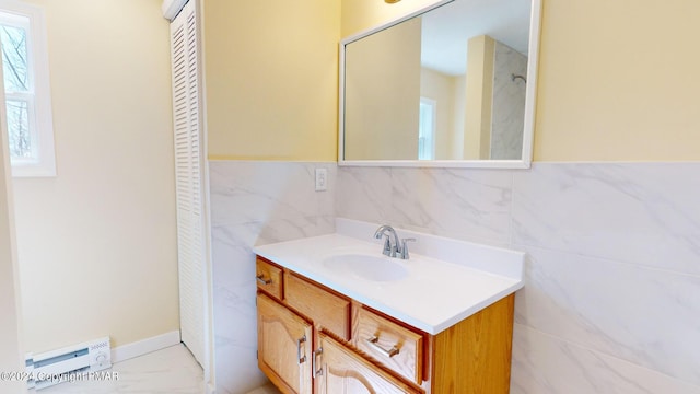 bathroom featuring tile walls, marble finish floor, and vanity