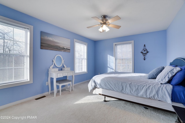 bedroom featuring carpet, baseboards, visible vents, and a ceiling fan