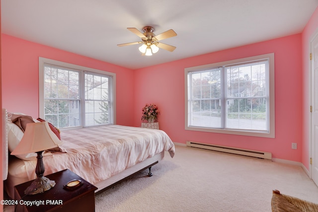 bedroom featuring carpet, baseboards, baseboard heating, and a ceiling fan