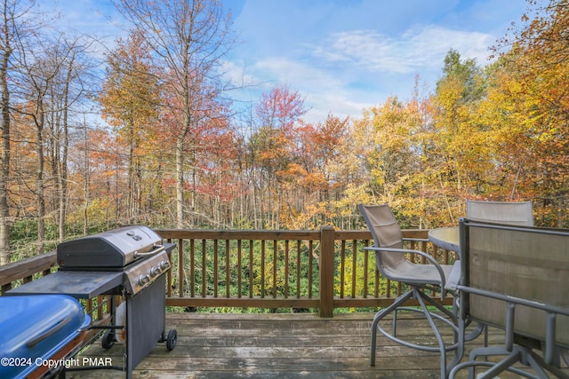 wooden terrace with a grill