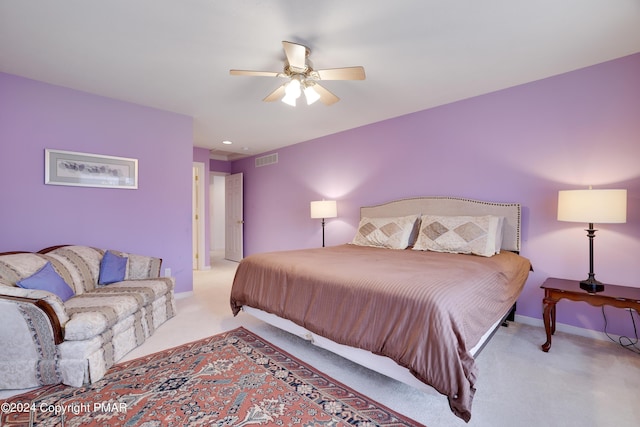 bedroom featuring light carpet, baseboards, visible vents, and a ceiling fan