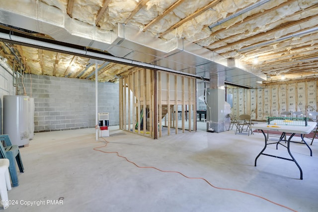 unfinished basement with water heater and heating unit